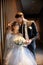 Bride and groom hugging and kissing while standing on the stairs. Wedding, gentle embrace of man and woman