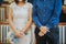 Bride and groom in informal outfits standing by the