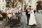 Bride and groom kiss behind horses somewhere in the old part of