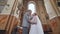Bride and groom kissing in a Catholic church.