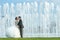 Bride and groom kissing in front of water fountain