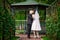 Bride and groom kissing near the gazebo in the park