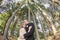 Bride and Groom kissing under trees