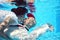 Bride and groom kissing underwater dive pool water rose