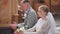 A bride and groom kneel in a Catholic church during a wedding.