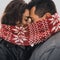 Bride and groom in love couple in knitted scarf and mittens in winter with snow