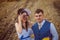 Bride and groom near hay on a rural field