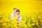bride and groom outdoor sunlight standing in a yellow field hug, portrait newlyweds kiss autumn in nature