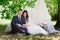 Bride and groom outdoors smiling cuddling and reading books, decor, peonies, flowers, lifestyle, marriage, family, love