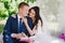 Bride and groom outdoors smiling cuddling and reading books, decor, peonies, flowers, lifestyle, marriage, family, love