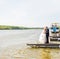 Bride and groom on pier. Wedding couple