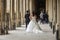 Bride and groom pose for wedding shots under Palais Royal arcade