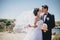 Bride and groom posing on the background of ancient ruins