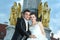 Bride and groom posing in front of fountain