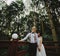 Bride and groom posing on the verandah