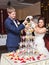 Bride and groom pouring champagne into the glass. Pyramid of champagne.