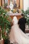 Bride and groom praying, standing on knees at Virgin Mary statue