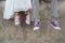 The bride and groom with purple and pink sneakers.