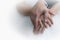 Bride and groom\'s hands with wedding rings (soft focus) .Cross p