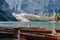 Bride and groom sailing in wooden boat, with oars at Lago di Braies lake in Italy. Wedding in Europe - Newlyweds are