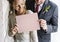 Bride and Groom Showing Blank Paper on Wedding Day