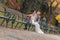 Bride and groom sitting on bench in a park