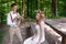 Bride and groom sitting in the summer park