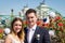 Bride and groom softly hugging on the terrace with Rome cityscape on background, Italy