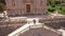 The bride and groom stand hugging on the ancient stairs of the Nativity of the Blessed Virgin Mary church