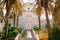 The bride and groom stand hugging and holding hands on the stairs of the Nativity of the Blessed Virgin Mary church in