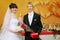 Bride and groom stand near banquet table