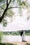 Bride and groom. Summer wedding. Outdoor portrait of happy beautiful newlyweds looking at lake.
