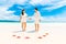 Bride and Groom on tropical beach shore with red starfish in the