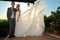 Bride and groom under a porch full length
