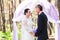 Bride and Groom Under wedding arch