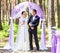 Bride and Groom Under wedding arch.