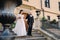 The bride and groom walk up the stairs of the Nesvizh Castle.The wedding couple descend from the stairs of the palace