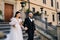 The bride and groom walk up the stairs of the Nesvizh Castle.The wedding couple descend from the stairs of the palace