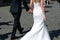 Bride and groom walking along the stony street