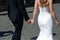 Bride and groom walking along the stony street