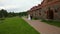 Bride and groom walking in the park of the old homestead. Camera crane shot