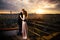 The bride and groom are watching the sunset. Couple on the roof. Lovers newlyweds on the background of the evening city. The sun