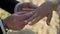 Bride and groom at wedding ceremony. Man put on a ring on a woman finger.