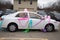 A bride and groom white get away car all decorated