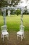 Bride and groom white seat chair in summer wedding arch decorated for secular wedding ceremony