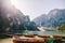 Bride and groom in a wooden boat at the Lago di Braies in Italy. Wedding couple in Europe, on Braies lake, in the