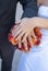 Bride and grooms hands, rings and bouquet.