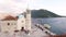 Bride and guests stand in front of the Church of Our Lady of the Rocks. Bay of Kotor