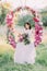 The bride with the hair accessories holding the bouquet of peonies, looking at the ground and sitting in the wedding