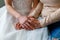 Bride on her wedding day holding her mother`s hands. Concept of